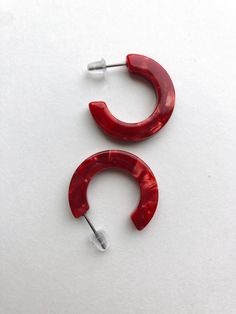 "These red acetate hoops are so easy to wear! Light weight yet slightly chunky to make a statement.  The acetate is a marbled mix of reds. Perfect for Valentine's Day and beyond!  They are less then 1\" in diameter." Modern Red Hoop Earrings, Trendy Red Resin Earrings, Small Hoop Red Earrings For Everyday, Red Small Hoop Earrings For Everyday, Small Red Hoop Earrings For Everyday Wear, Modern Red Small Hoop Earrings, Chic Acetate Jewelry, Modern Red Hoop Jewelry, Modern Small Red Hoop Earrings