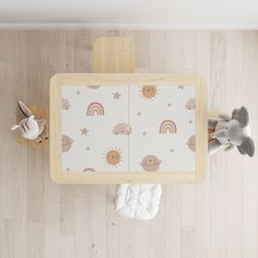 an overhead view of a baby's playroom with toys on the wooden floor