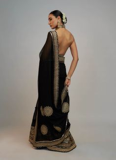 Editor's Note A classic drape sari with delicate gold embroidery lifts the patterns and add grace, paired with a beautiful bralette blouse speaks of opulence and grandeur, gold, jewel colours that are reminiscent of royalty! Elegant Festive Pre-draped Saree With Intricate Embroidery, Elegant Black Pre-draped Saree With Zari Work, Pre-draped Saree With Pallu For Evening Festivals, Elegant Pre-draped Saree With Dupatta For Festivals, Elegant Georgette Saree For Transitional Season, Traditional Pre-draped Saree For Evening Festivals, Elegant Pre-draped Georgette Saree With Zari Work, Traditional Pre-draped Saree With Zari Work For Evening, Traditional Evening Pre-draped Saree With Zari Work