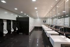 a public restroom with urinals and sinks