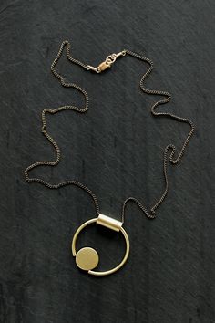 "PETITE ELORIA - By L.Greenwalt Jewelry Featured: Formed and soldered brass and sterling silver pendant on a sterling silver chain, also available in all brass. Tube / bale is not fixed allowing abstract movement of pendant. Pendant measures approximately 1.25\" in diameter. You choice of sterling silver chain or brass chain, 16.5\" or 28\". Always, all items come in a branded L.Greenwalt Jewelry box for whatever your occasion may be. Thank you so much for checking it out! L.Greenwalt Jewelry Co Architectural Jewelry, Fan Necklace, Rainbow Necklace, Small Circle, Geometric Circle, Eco Friendly Jewelry, Message Jewelry, Geometric Necklace, Geometric Jewelry