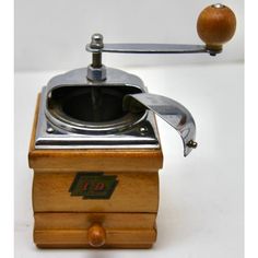 an old fashioned coffee grinder with a wooden handle