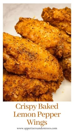 crispy baked lemon pepper wings on a white plate with the words crispy baked lemon pepper wings