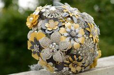 a bridal bouquet sitting on top of a stone wall