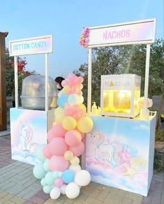 an ice cream stand with balloons on it