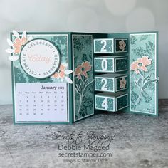 the inside of an open card with flowers on it and calendars in each corner