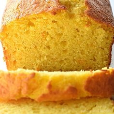 a loaf of bread sitting on top of a white table next to a slice of cake