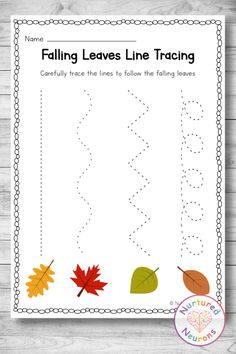 the fall leaves line traceing worksheet is shown on a wooden table with a white