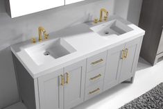 two white sinks sitting next to each other on top of a bathroom vanity under a mirror