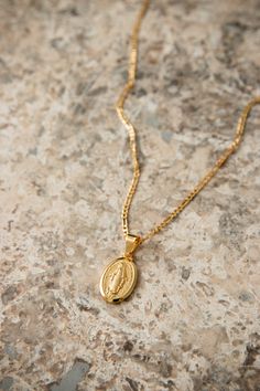 Our Sorrento Necklace features a Virgin Mary coin pendant on a classic Figaro chain. PRODUCT DETAILS 18k Gold plated pendant & chain unisex: for women & men Nickel free SIZING & MEASUREMENTpendant size: 1.5cm x 3.5cm, chain 2mm x 60cm long CARE For the longest shine avoid contact with water, perfume, moisturizer and hairspray. We recommend you remove your jewelry when showering, exercising, at the beach, or swimming in chlorinated water. All pieces featuring pearls and natural gemstones are very Gold Coin Jewelry, Saint Necklace, Catholic Necklace, Virgin Mary Necklace, Water Perfume, Gold Chain With Pendant, Figaro Chain