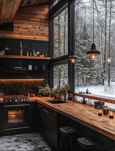 a kitchen with an oven, stove and counter top in front of a large window