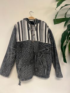 "Handcrafted : Each jacket is a unique creation by Nepali artisans, featuring vibrant patterns and intricate stitches. Unisex and Versatile: Suitable for everyone, perfect for both outdoor cold and indoor comfort. Eco-Friendly Comfort: Made from 100% cotton, offering breathability and coziness with added pockets for convenience. Additional Front Pocket included. Each purchase supports the skilled hands that bring these jackets to life, fostering sustainable practices and empowering communities in Nepal. Sizing Small(S) : Chest: 21\" | Length: 26\" | Shoulder: 18\" |  Sleeve Length: 22.5\"   | Arm Hole: 10\" Medium (M): Chest: 22\" | Length: 27\" | Shoulder: 18.5\" |  Sleeve Length: 23\" | Arm Hole: 10.5\" Large(L): Chest: 23\" | Length: 28\" | Shoulder: 19\" | Sleeve Length: 23.5\"   | Arm Hooded Cotton Top For Festivals, Bohemian Hooded Top For Fall, Black Bohemian Cotton Outerwear, Traditional Winter Festival Tops, Black Bohemian Hoodie, Bohemian Black Hooded Hoodie, Bohemian Multicolor Long Sleeve Hoodie, Bohemian Cotton Hoodie For Fall, Hippie Hooded Festival Hoodie