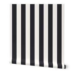 a black and white striped wallpaper with vertical stripes on the bottom half of it