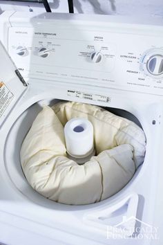 a white washer with a roll of toilet paper in it