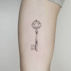 a small key tattoo on the right thigh