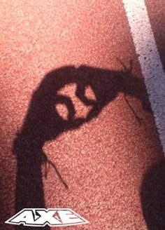 the shadow of a person holding a tennis racquet