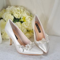 A Classic Bridal Shoe, these Satin Pointed Toe Shoes are available in a range of colours. Design Details: * Handmade Shoes * Bridal Satin Shoes  * Comfortable Shoes with cushioned insoles. * Heel Height: 9cm * Colour Availability: Ivory or White * Stiletto Heel * Pointed Toe * Removable 3D Floral Shoe Clip Included with your order: * Handmade shoes with cushioned soles for extra comfort. * Shoes can be made to your measurements. - www.etsy.com/uk/listing/1177895287 * Custom order accepted on mos White Stiletto Heels, Custom Wedding Shoes, Shoes For Bride, White Stilettos, Bridal Shoe, Flower Shoes, Satin Shoes, Crystal Shoes, Floral Shoes