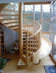 there are two pictures of a spiral staircase in the same room, and one is empty