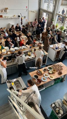 a large group of people in a kitchen preparing food