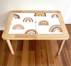 a small wooden table with colorful designs on it