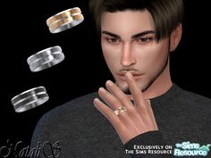 the man is wearing three different rings on his finger