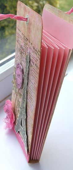 an old pink fan sitting on top of a window sill