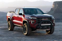 a red truck parked on top of a mountain