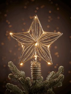 a christmas tree topper with lights in the shape of a star