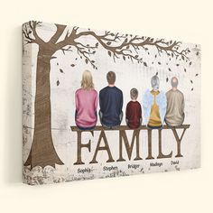 a family is sitting on a bench under a tree with their names painted on it