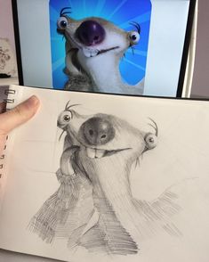 a person holding up a drawing of a dog with its mouth open and tongue out