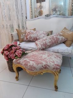 a couch with pillows and flowers on it