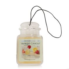 yankee candle with an orange, lemon and raspberry design on the front side