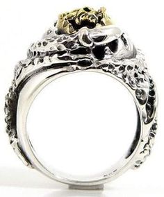 "This ring has a dark and mysterious style that takes its inspiration from the Grim Reaper. With gothic accents, it features the elusive face of this all-powerful personification picked out in rich 14k yellow gold overlay. Around him, a swirling vortex of scaled coils seem to twist and turn - in a manner reserved exclusively for the underworld. This accessory is certainly not one for the weak hearted. It stands bold and proud from any finger with a solid sterling silver body that will last the t Collectible Gothic Skull Ring, Gothic Skull Collectible Rings, Gothic Skull Rings For Collectors, Gothic Skull Ring For Formal Occasions, Formal Gothic Skull Ring, Mysterious Style, Grim Reaper Skull, Onyx Ring Men, Mens Cross Necklace