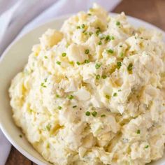 creamy classic potato salad in a white bowl on a wooden table with text overlay