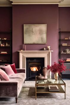 a living room filled with furniture and a fire place under a painting on the wall