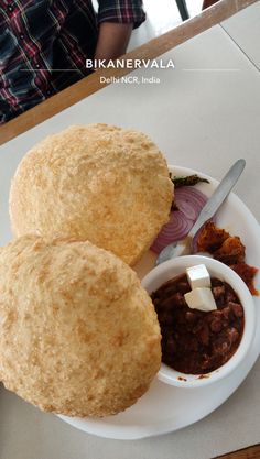 some food is on a white plate with a spoon