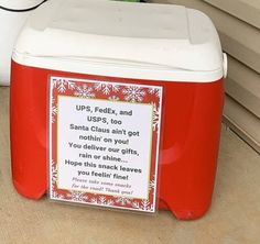 a red and white cooler sitting on top of a wooden floor next to a wall