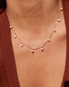 This lightweight and delicate piece features dangle pearl charms that make it perfect for both everyday wear and special occasions. The adjustable length ensures a comfortable fit, while the PVD plated finish ensures that your necklace stays water safe and tarnish resistant. Create a chic and minimal pearl look by layering the Calypso Necklace with your favorite pieces. •Single Necklace• Faux Pearls• 15.5" + 2" extender (to make adjustable) Everyday Pearl Drop Dangle Necklace, Dainty Pearl Dangle Drop Necklace, Dainty Pearl Drop Dangle Charm Necklaces, Dainty Adjustable Pearl Charm Necklaces, Adjustable Dainty Pearl Charm Necklaces, Adjustable Minimalist Pearl Charm Necklace, Adjustable Dainty Pearl Charm Necklace, Dainty Adjustable Pearl Charm Necklace, Dainty Pearl Charm Necklace With Dangle