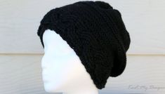 a white mannequin head wearing a black knitted hat