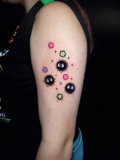 a woman's arm with an eyeball tattoo design on the left upper arm