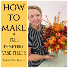 a woman holding a vase filled with flowers on top of a white table next to a yellow sign that says how to make a fall cemetery vase filler