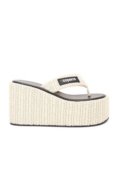 Raffia upper with rubber sole.  Made in Italy.  Slip-on styling.  Faux leather footbed.  Thong styling.  Wedge heel.  .  Approx 50mm/ 2 inch platform, Approx 95mm/ 3.75 inch heel.  .  .  .  .  .  .  .  . Beige Straw Wedge Sandals With Textured Sole, Chic Wedge Sandals With Textured Footbed For Vacation, Chic Vacation Wedge Sandals With Textured Footbed, Chic Textured Footbed Wedge Sandals For Vacation, Chic Straw Platform Wedge Sandals, Chic Beach Platform Slippers With Textured Footbed, Beach Wedge Heels With Textured Footbed, Beach Heels With Textured Footbed And Wedge Heel, Wedge Heels For Beach With Textured Footbed