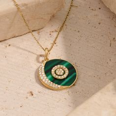 Discover lunar elegance with our Green Enamel Moon and Orbit Necklace, a celestial symphony of elegance and style. This enchanting piece features a fine gold chain adorned with a mesmerizing moon and orbit pendant on vivid green enamel. Inspired by the cosmos, this necklace captures the magic of the night sky, making it a celestial and elegant addition to your jewelry collection. - Made in 14k solid gold - Decorated with handset white cubic zirconia stone - Finished with Green Enamel - Pendant d Elegant Circle Necklace With Polished Finish, Luxury Moon Charm Pendant Jewelry, Celestial Pendant Necklace For Formal Occasions, Celestial Pendant Necklace For Formal Events, Elegant Round Pendant Jewelry With Moon Phase, Elegant Round Pendant With Moon Phase Jewelry, Elegant Round Moon Charm Necklace, Elegant Round Necklace With Moon Charm, Elegant Moon Phase Round Pendant Jewelry