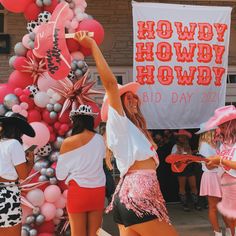 two women dancing in front of balloons and a sign that says howdyhowy