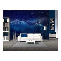 a living room filled with furniture and a night sky mural on the wall behind it