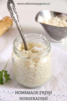 a jar filled with rice sitting on top of a table next to a measuring spoon