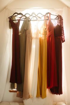 there are many dresses hanging on the rack