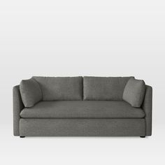 a gray couch with pillows on it