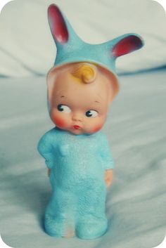 a small blue toy with ears on it's head