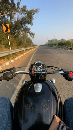 a person on a motor bike riding down the road